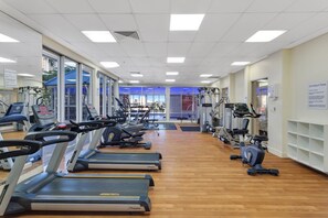 A gym with treadmills, stationary bikes, and weight machines.