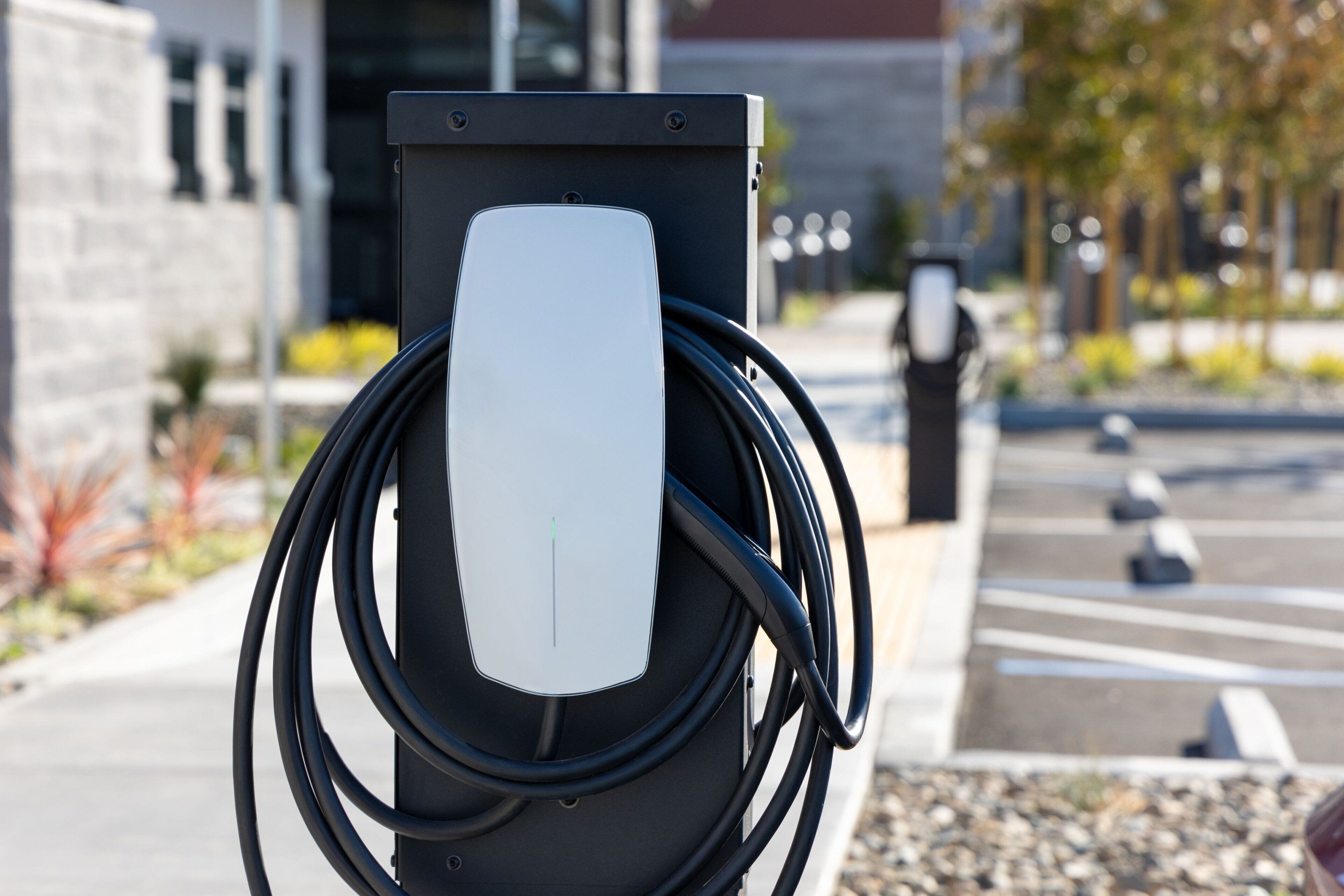 An electric vehicle charging station with a cable connected to it.