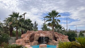 A rock formation with a water feature and steps leading up to it. - Resort Living Las Vegas (Las Vegas)