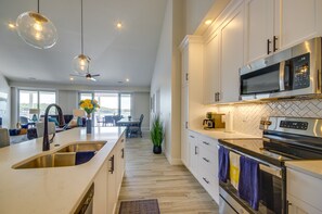 Enjoy cooking in this well-lit kitchen with a central island, microwave, and large oven.