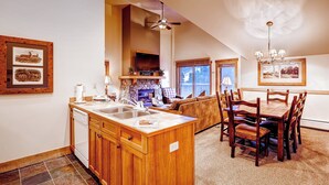 A spacious kitchen with a central island, wooden cabinets, and a built-in stove. - River Run Village |  Cozy 1BR for 6 | Pool Access (Keystone)