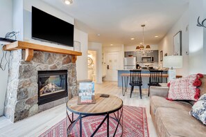 Relax in this inviting living room with a fireplace, flat-screen TV, and comfortable seating area.