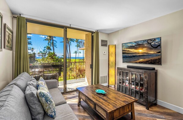 A living room with a sofa, a coffee table, a TV, and a cabinet.