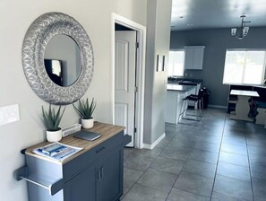 Enjoy a stylish space with a large mirror, kitchen area, and dining table.