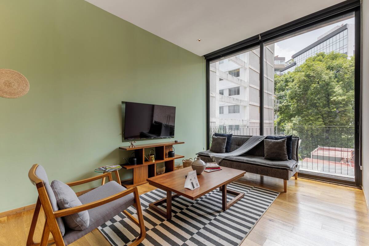 A modern living room with a sofa, coffee table, and TV.