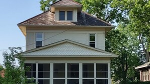 A two-story house with a large front porch and a small attic window. - 1910 Family Home near Lake Winnebago, available for EAA (Oshkosh)