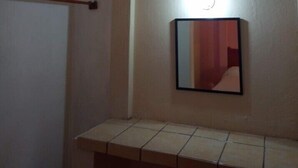A bathroom with a mirror, a towel rack, and a light fixture. - Casa Mamá Maya   (Puerto Escondido)