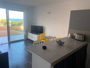 Enjoy cooking in the well-equipped kitchen with a large countertop, flat-screen TV, and toaster.