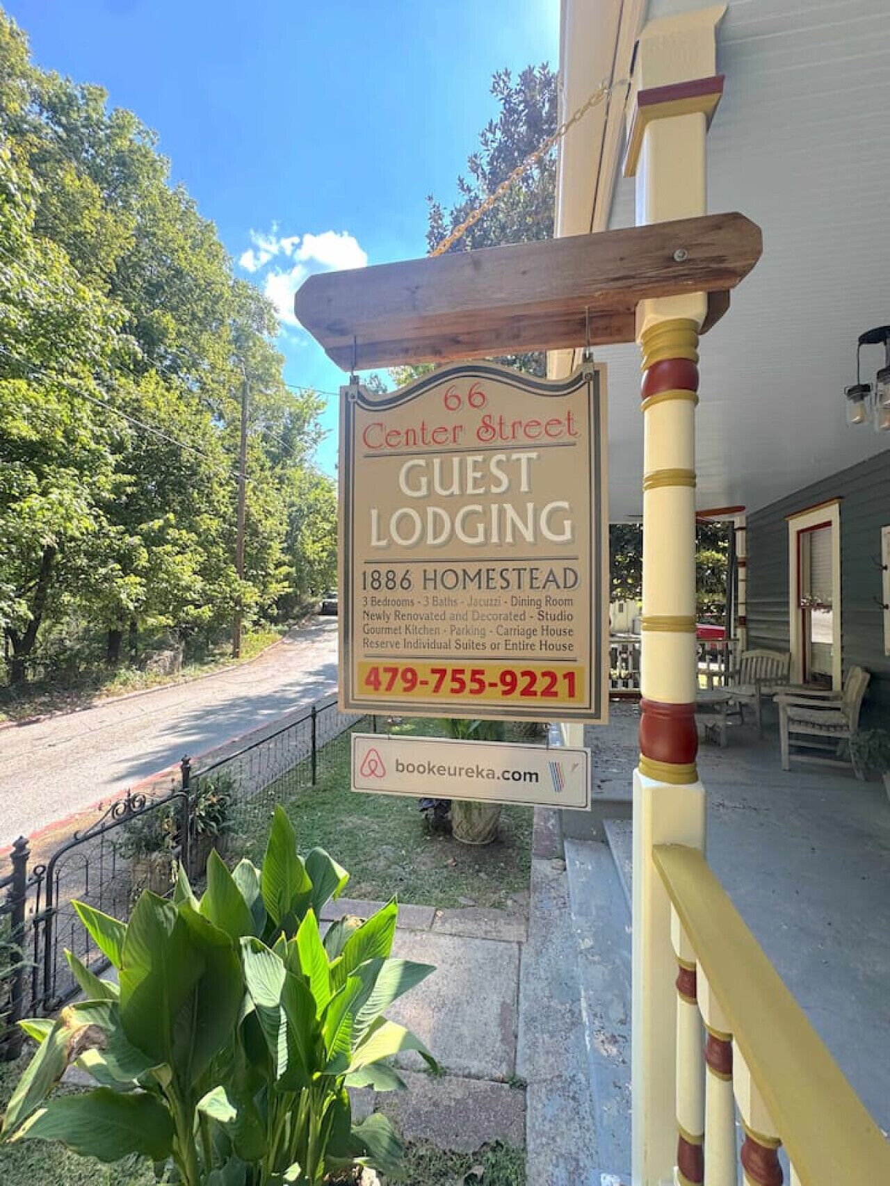 A guest lodging sign for 66 Center Street, 1886 Homestead, with amenities including 3 bedrooms, 3 baths, a dining room, newly renovated and decorated studio, gourmet kitchen, parking, carriage house, and a reserve for individual suites or the entire house.