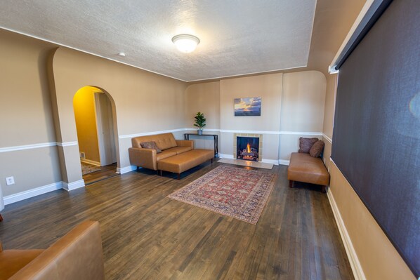 A living room with a fireplace, a sofa, and a rug. - Quiet, private, cozy home (Ogden)