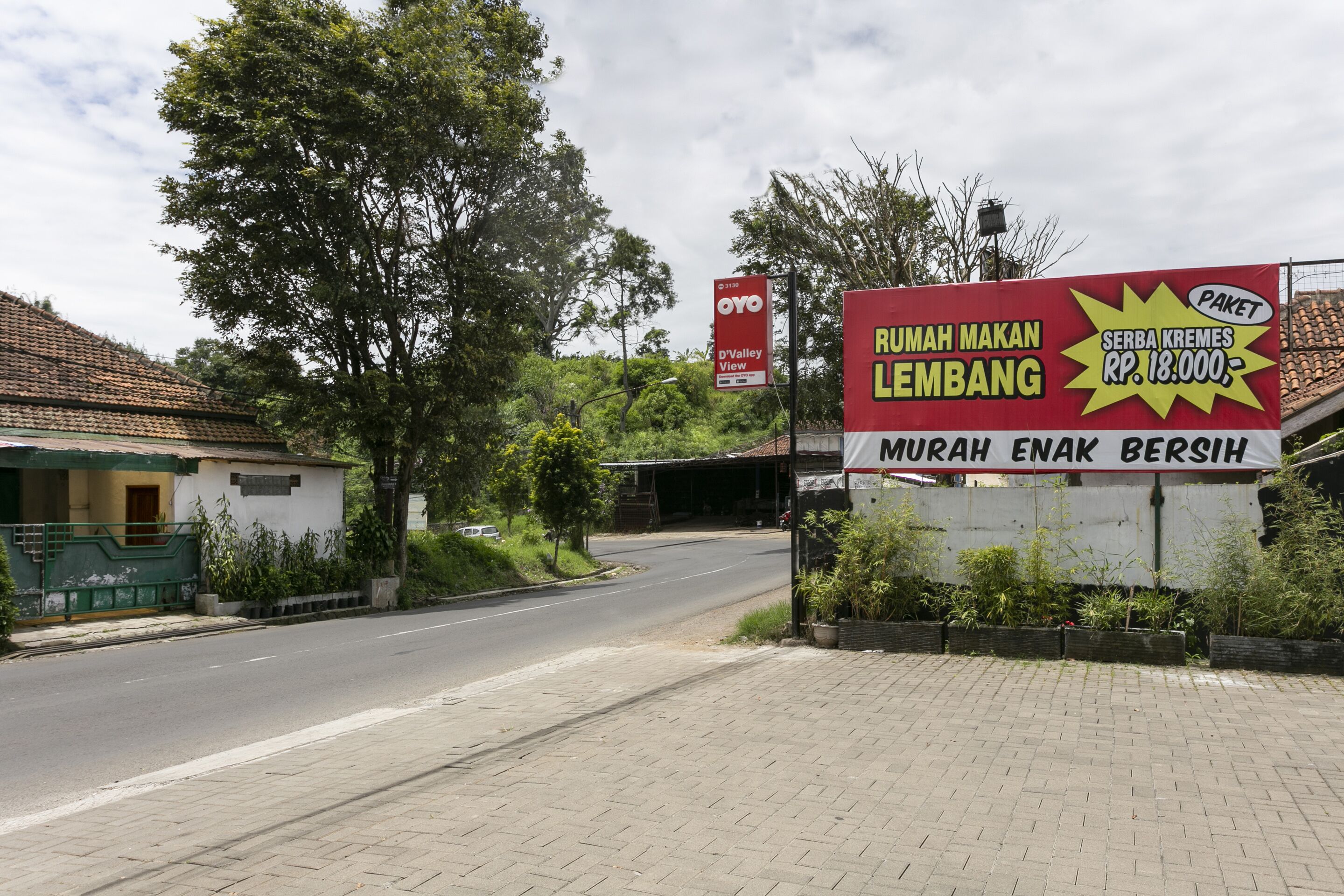 A road leading to a building with a sign advertising a package deal.