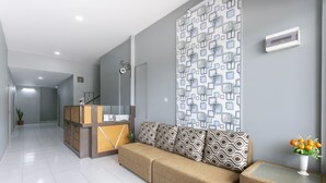 A modern living room with a sofa, a coffee table, and a decorative wall panel. - Collection O 3130 D'Valley View (Lembang)