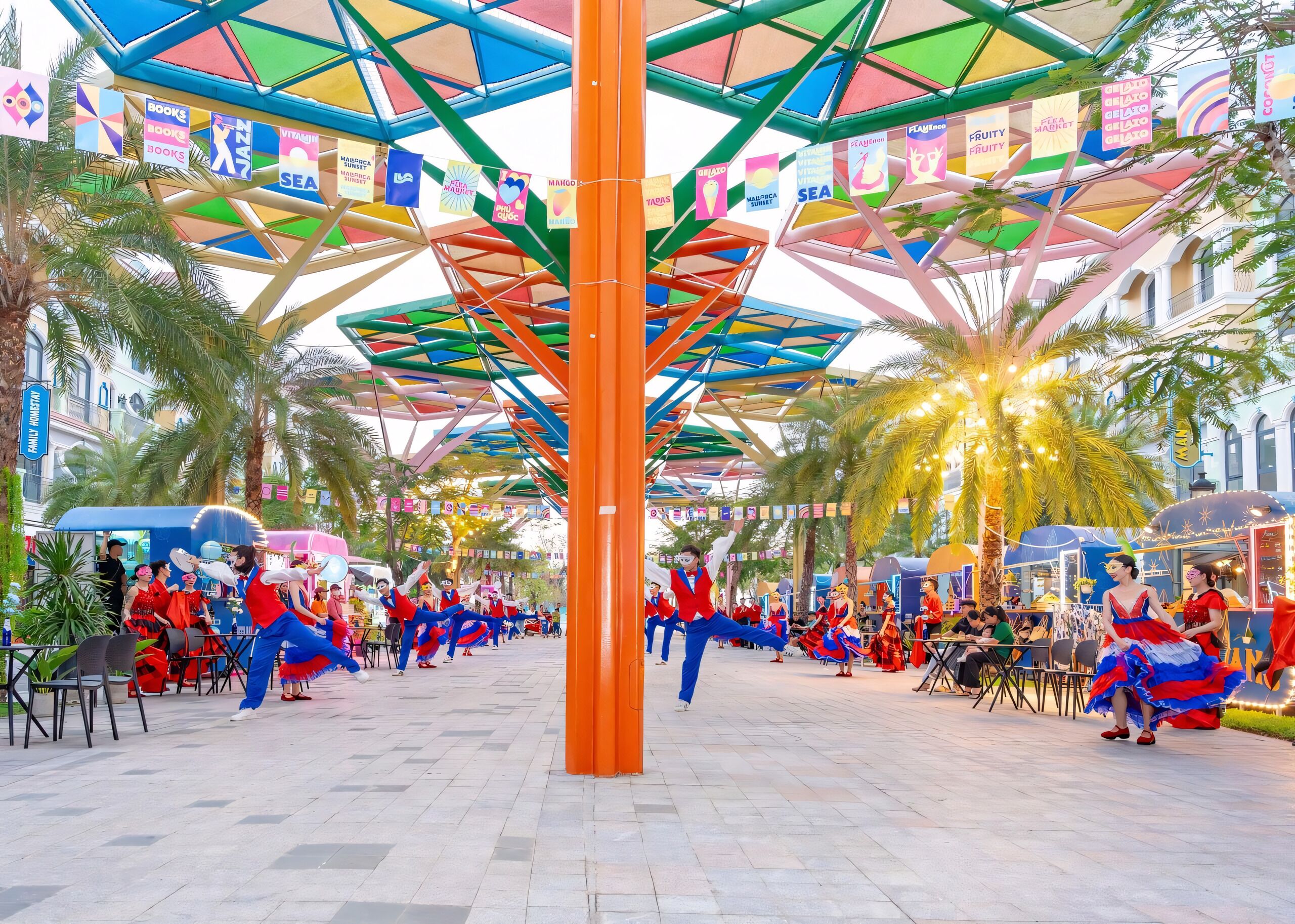 A vibrant outdoor plaza with a colorful geometric roof structure, palm trees, and various stalls.