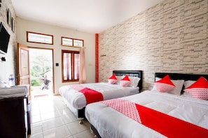 A hotel room with two beds, a brick wall, and a view of the outdoors. - Super OYO 2961 Artana Bed & Breakfast (Pangalengan)