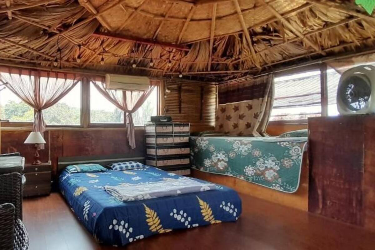 A room with a bed, a desk, a chair, and a window.
