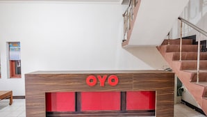 A reception desk with the name "OYO" prominently displayed. - Hotel O Transit 1 (Makassar)
