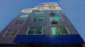 A tall building with multiple windows and air conditioning units. - MeroStay 117 Siddhi Binayak Hotel (Tohka)
