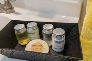 A black tray with Terra Pure products including shampoo, body lotion, and cleansing bar.