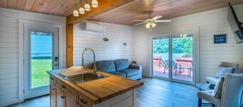 Cozy lakefront retreat with private dock, scenic views, updated interiors and serene outdoor seating