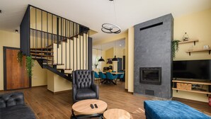 A modern living room with a staircase, a fireplace, and a dining area. - Luxury Villa Istra Maruzini with private pool in Rovinj,  Istria (Maružini)