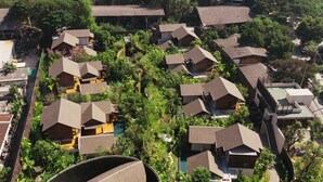 An aerial view of a residential area with multiple houses, surrounded by lush greenery and trees. - Rarin Villas (Chiang Mai)