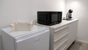 A compact kitchen with a microwave, a coffee machine, and a small refrigerator. - La Torre - Prestige Penthouse (Santo Stefano di Camastra)