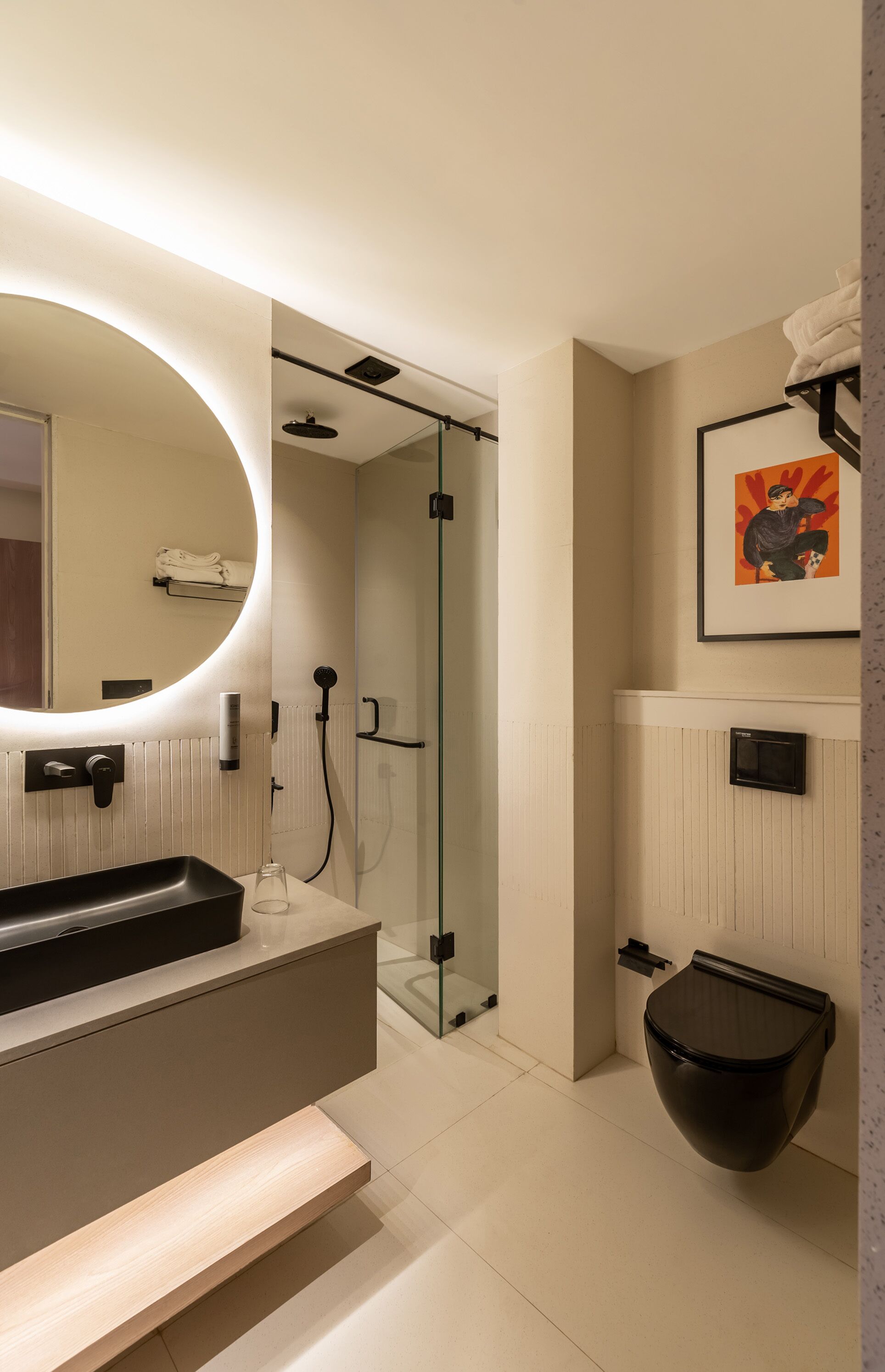 Ein modernes Badezimmer mit großem Spiegel, Waschbecken, Toilette und Duschkabine.