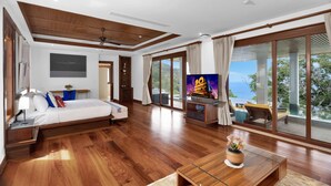 A spacious bedroom with a large bed, a TV, and a balcony with a view of the sea. - Villa Varya (Kamala)