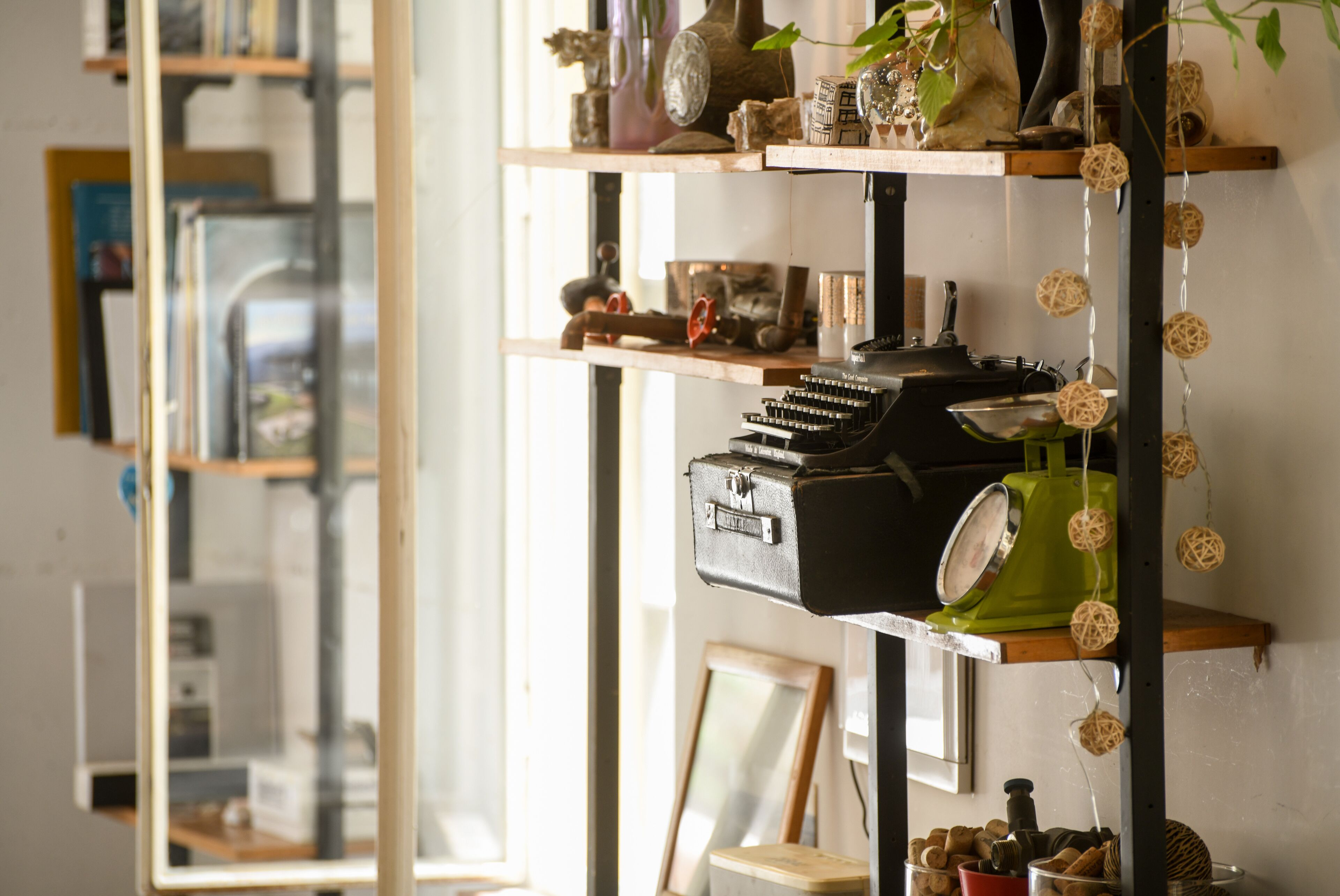 A shelf with various items including a vintage radio, books, and decorative objects.