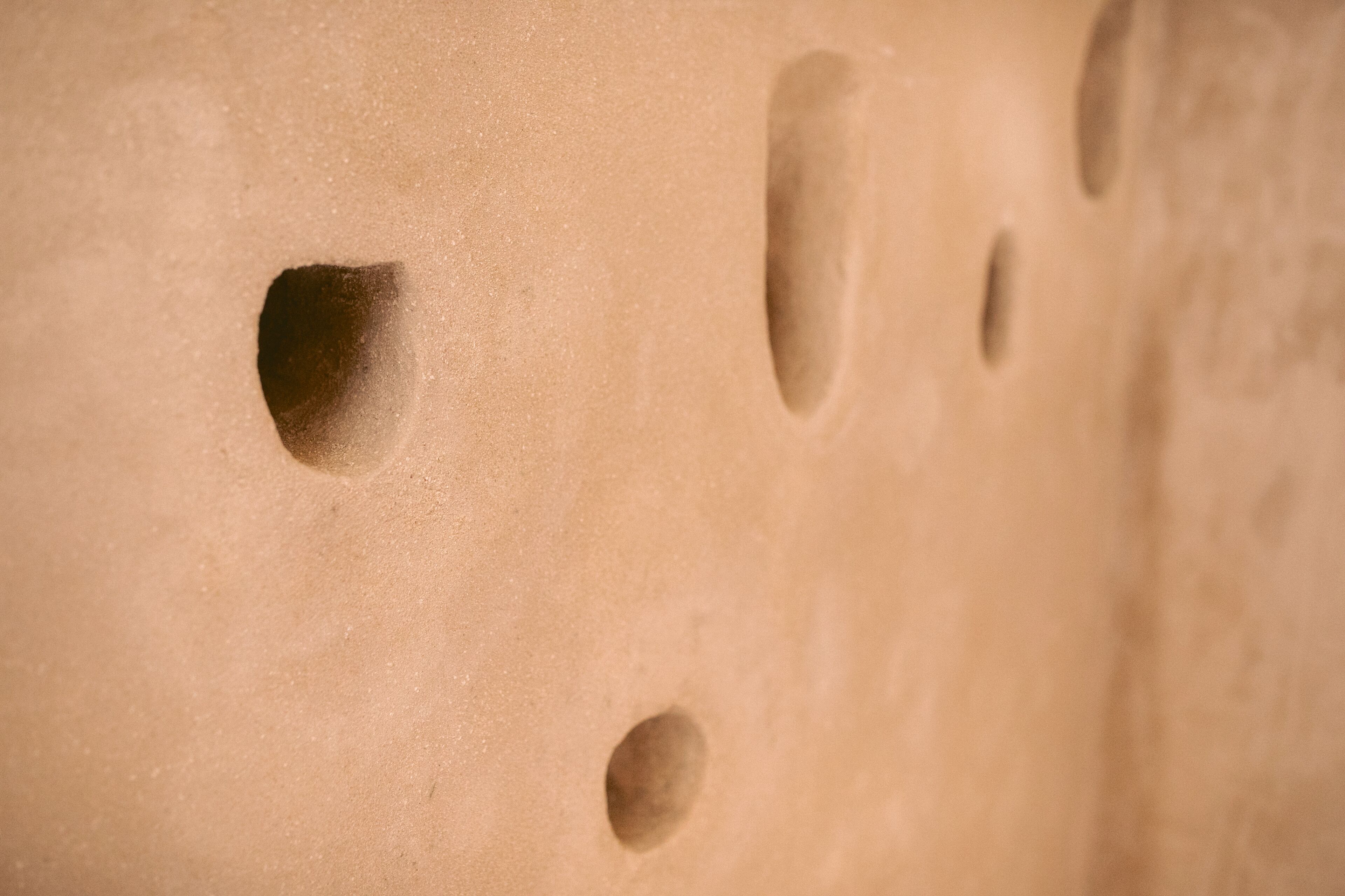 A close-up of a textured surface with multiple circular indentations.