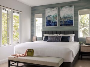 A bedroom with a large bed, two windows, and two abstract paintings on the wall. - Peppers Beach Club & Spa Palm Cove (Cairns)