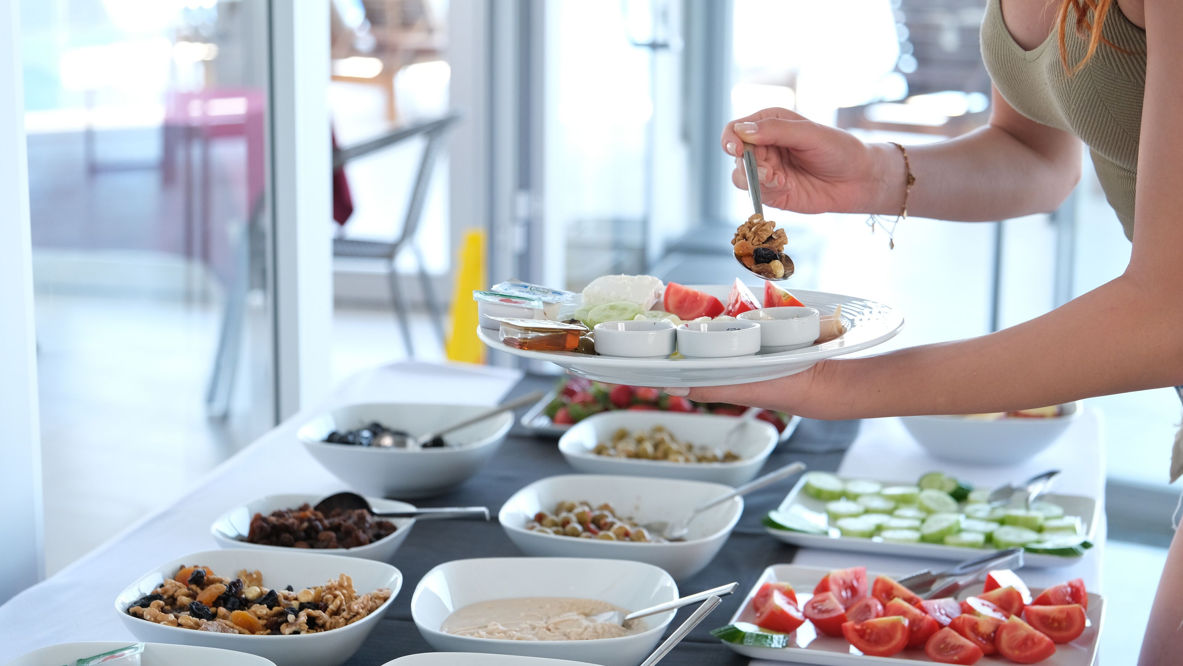 A buffet with various food items including fruits, vegetables, and dips.