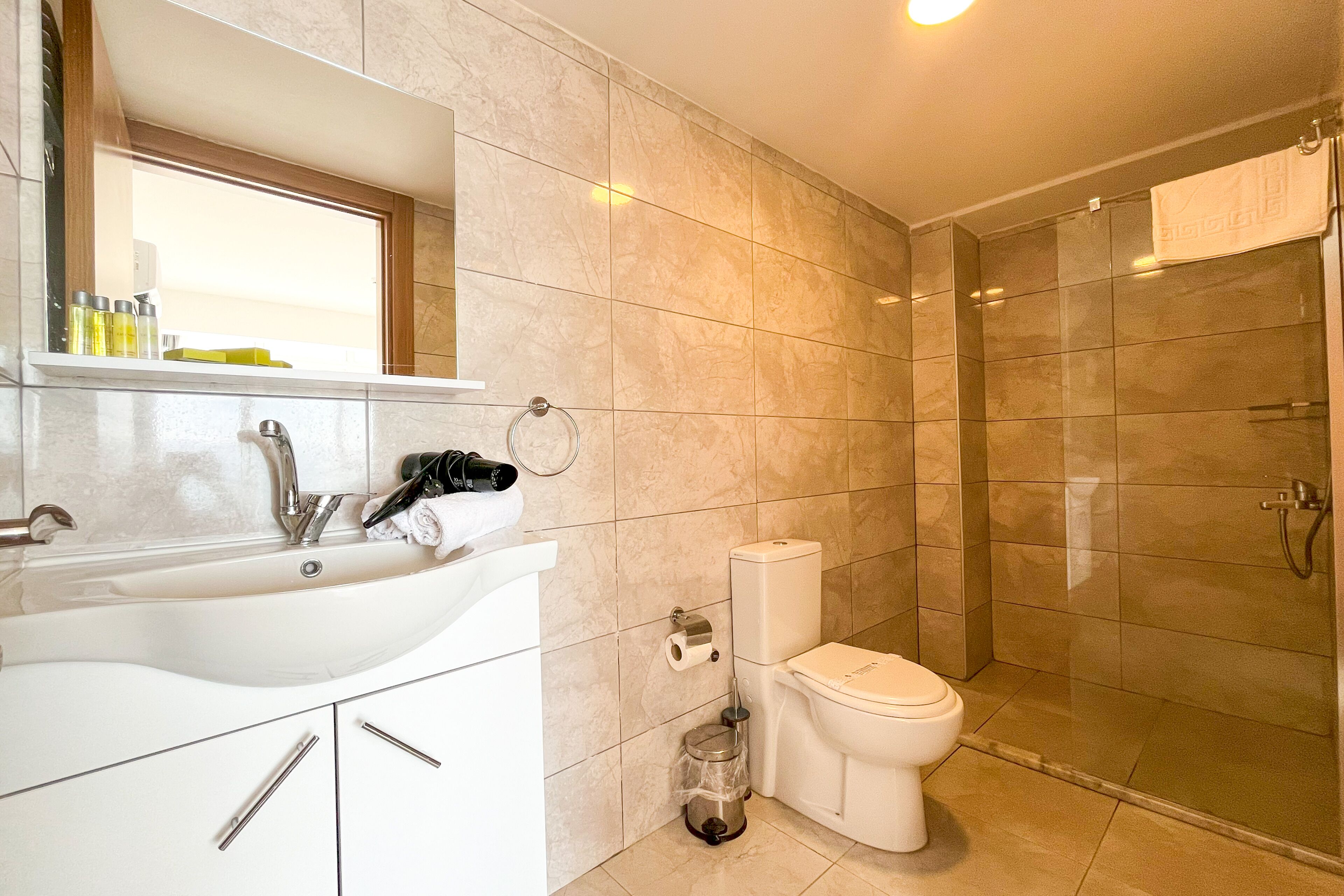 shower, hair dryer, slippers, towels