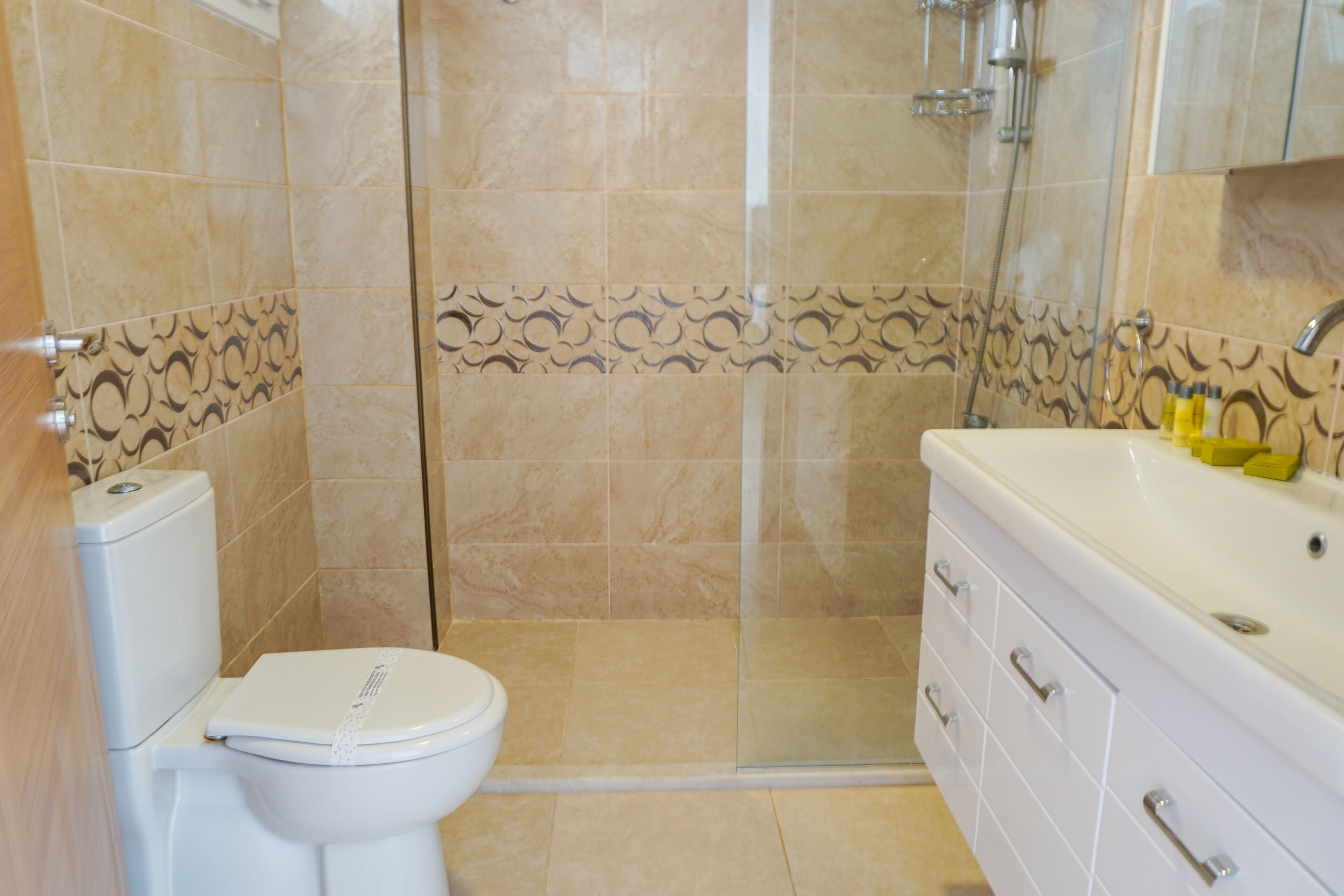 shower, hair dryer, slippers, towels