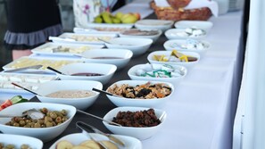 A buffet table with various food items in bowls, including fruits, nuts, and other snacks. - Ni Marin Hotel (Milas)