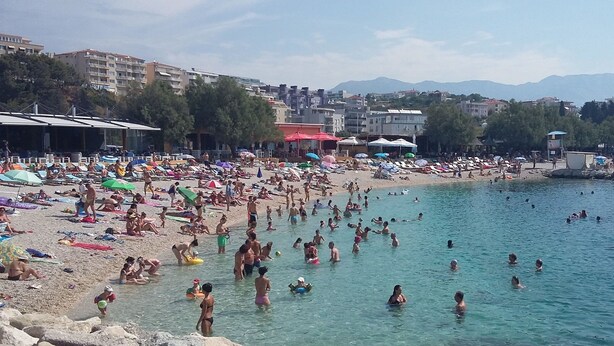 A crowded beach with people sunbathing and swimming. - Apartment Blaue Adria (Split)