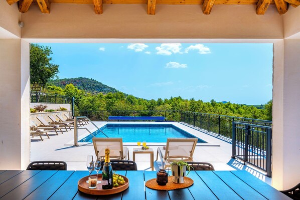 Outdoor pool, a heated pool, open open 24 hours a day, pool loungers