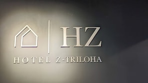 A hotel sign with the name "HOTEL Z-TRILOH" and a stylized house icon. - U by Z Hotels Bellandur (Bengaluru)