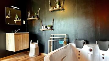 A modern bathroom with a wooden vanity, a large bathtub, and multiple shelves with plants and toiletries.