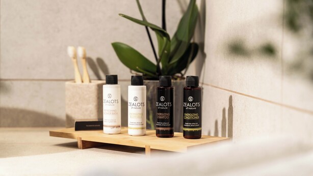 A wooden shelf with four bottles of Zealots of Nature products. - Private Jacuzzi Villa w/sunset view 6' from sea (OÃ­a)