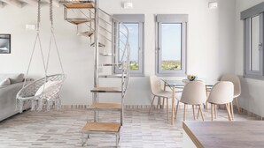 A modern interior with a spiral staircase, a hanging chair, a dining area with chairs, and a view through large windows. - Private Jacuzzi Villa w/sunset view 6' from sea (OÃ­a)