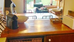 A kitchen with a large bowl, a toaster, and a wicker basket.