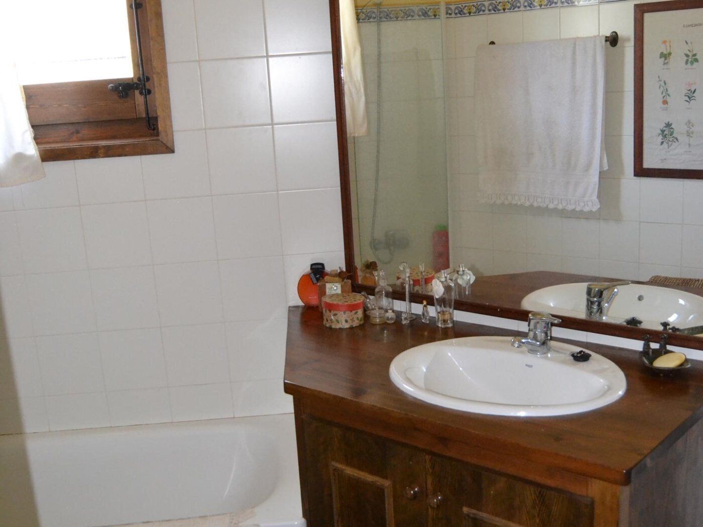 A bathroom with two sinks, a wooden vanity, and a mirror.