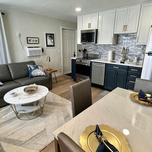 A compact living space with a dining area, kitchenette, and a sofa. - The Turtle Nest 5 in Fort Myers Beach (Fort Myers Beach)