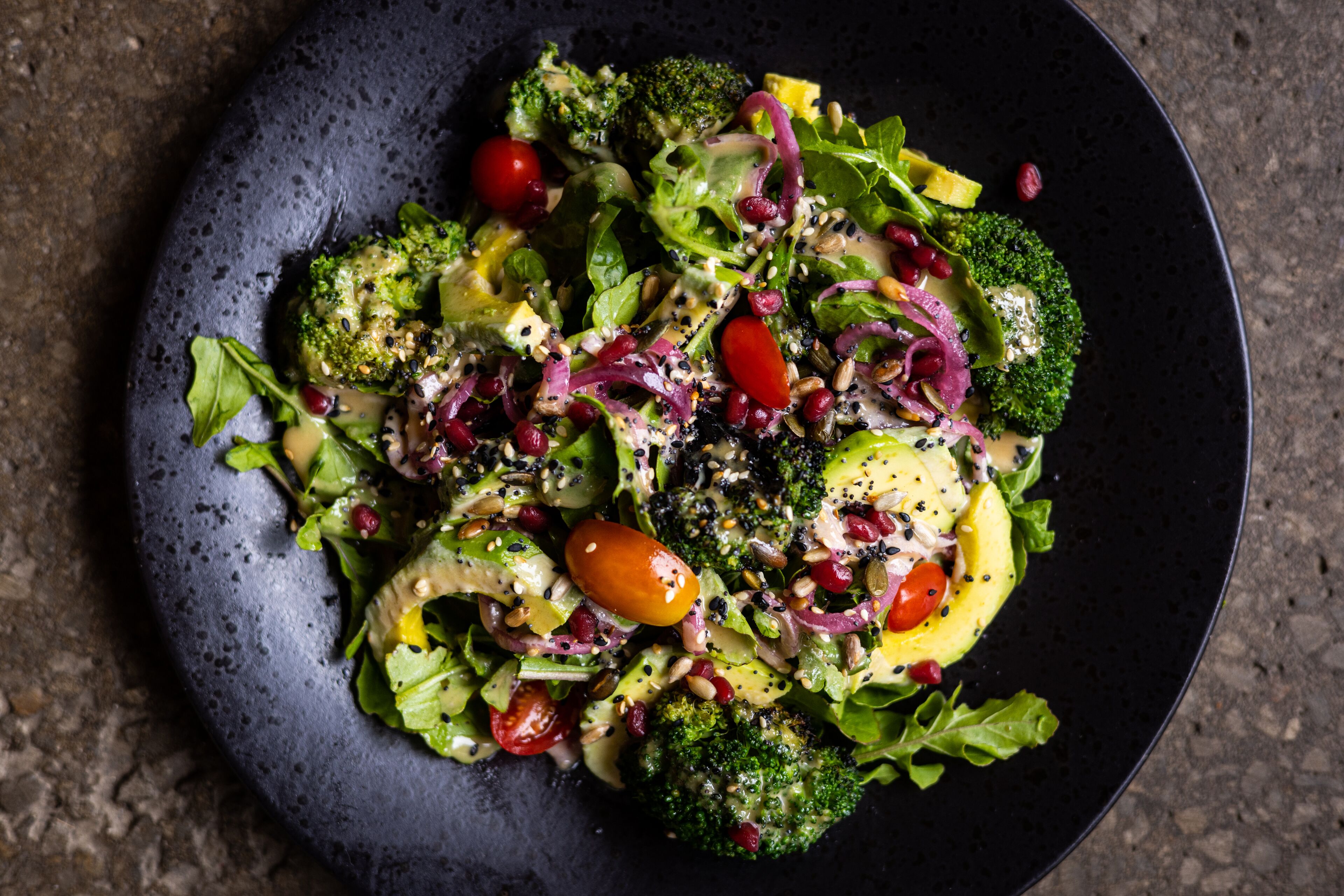 A salad with various vegetables and toppings on a plate.