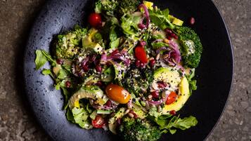 A salad with various vegetables and toppings on a plate.