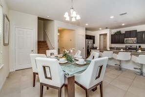 Enjoy meals in the kitchen with stainless steel appliances and a central island, then dine at the glass-top table with comfortable seating.