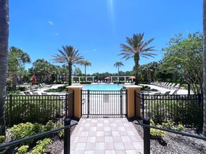 A pool area with a clear view of the pool, surrounded by palm trees and lounge chairs. - Private Pool Lakeview! Resort Near Disney! 237 (Davenport)