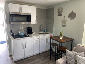 Fridge, microwave, stovetop, coffee/tea maker