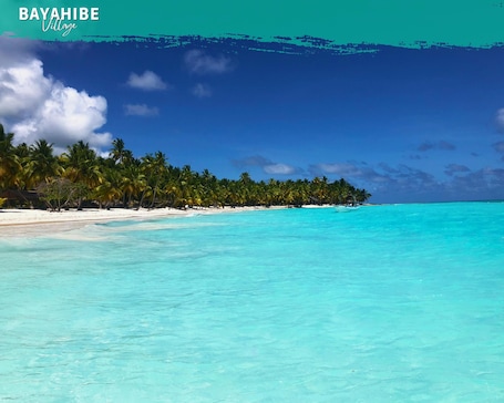 Beach nearby, white sand, sun loungers, beach bar. Tribe Inn & Rooftop Lounge